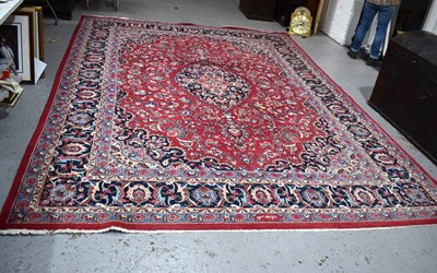 Lot 607 - A large Middle Eastern red ground rug with...