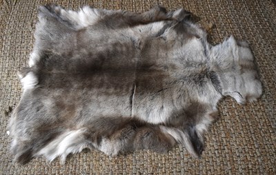 Lot 411a - A reindeer hide rug / throw, 86cm by 132cm.