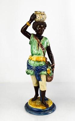 Lot 128 - A 19th century majolica figure of an African...