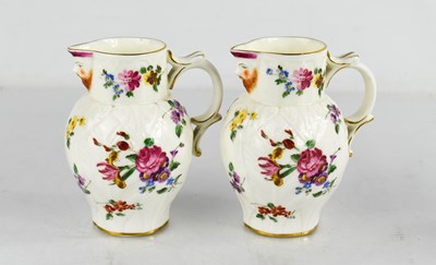 Lot 47 - A pair of Royal Worcester leaf moulded jugs...
