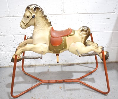 Lot 32 - A vintage tin plate rocking horse, the horse...