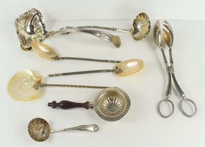 Lot 164 - A sterling silver tea strainer with turned...