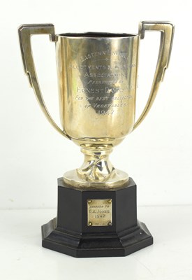 Lot 165 - A silver trophy, with twin handles and bearing...