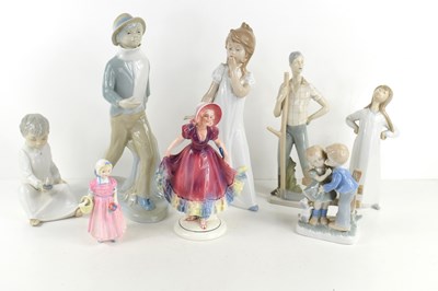 Lot 197 - A group of porcelain figures to include Lladro...