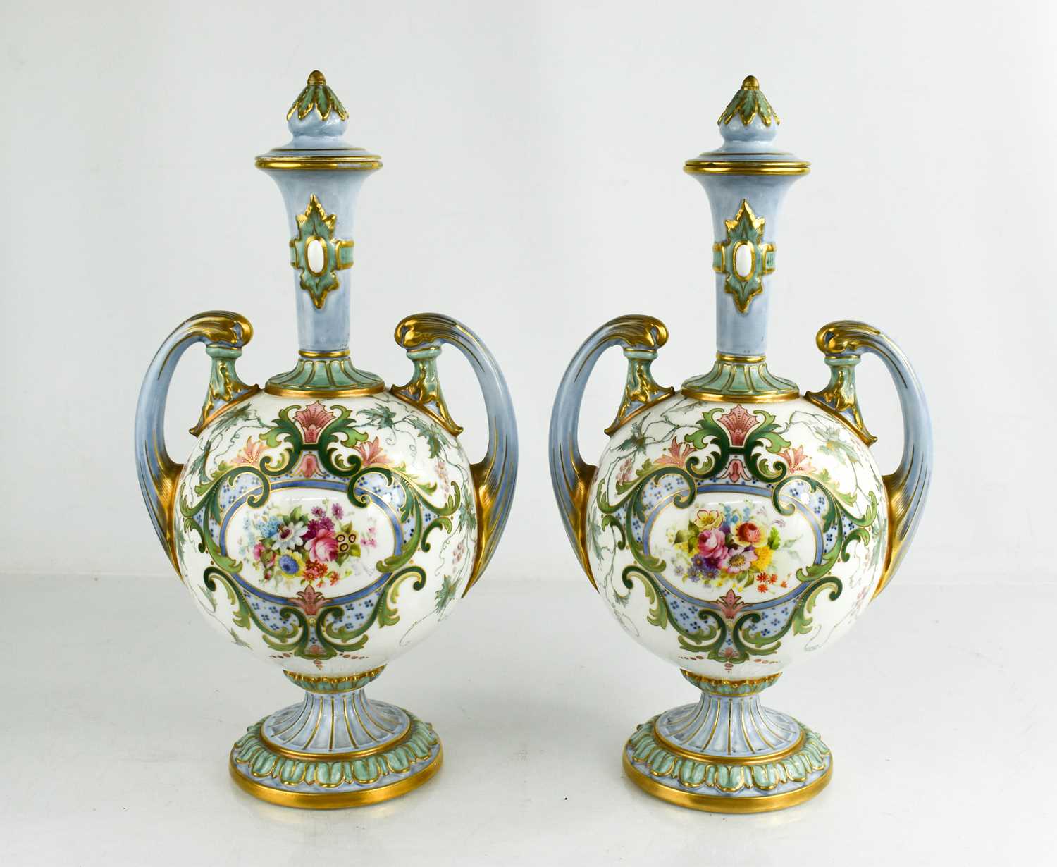 Lot 4 - A pair of Royal Worcester vase and covers,...