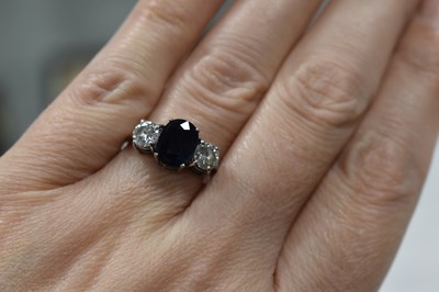 Lot 19 - An 18ct white gold, diamond and sapphire three...