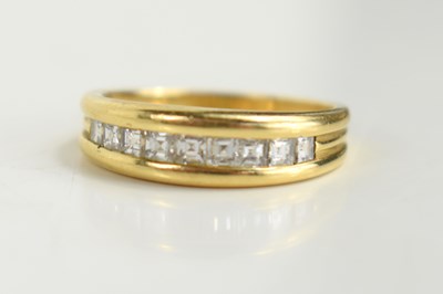 Lot 141 - An 18ct gold and diamond half eternity ring,...