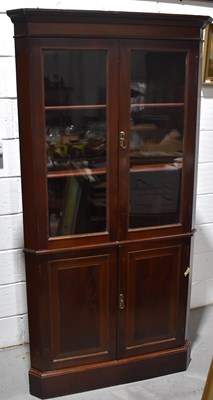 Lot 614 - A modern mahogany corner cupboard, the top...