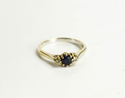 Lot 103 - A 9ct gold, sapphire and diamond three stone...