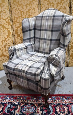 Lot 649 - A 20th century wingback armchair, in tweed...