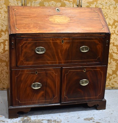 Lot 613 - A 19th century mahogany bureau having two...