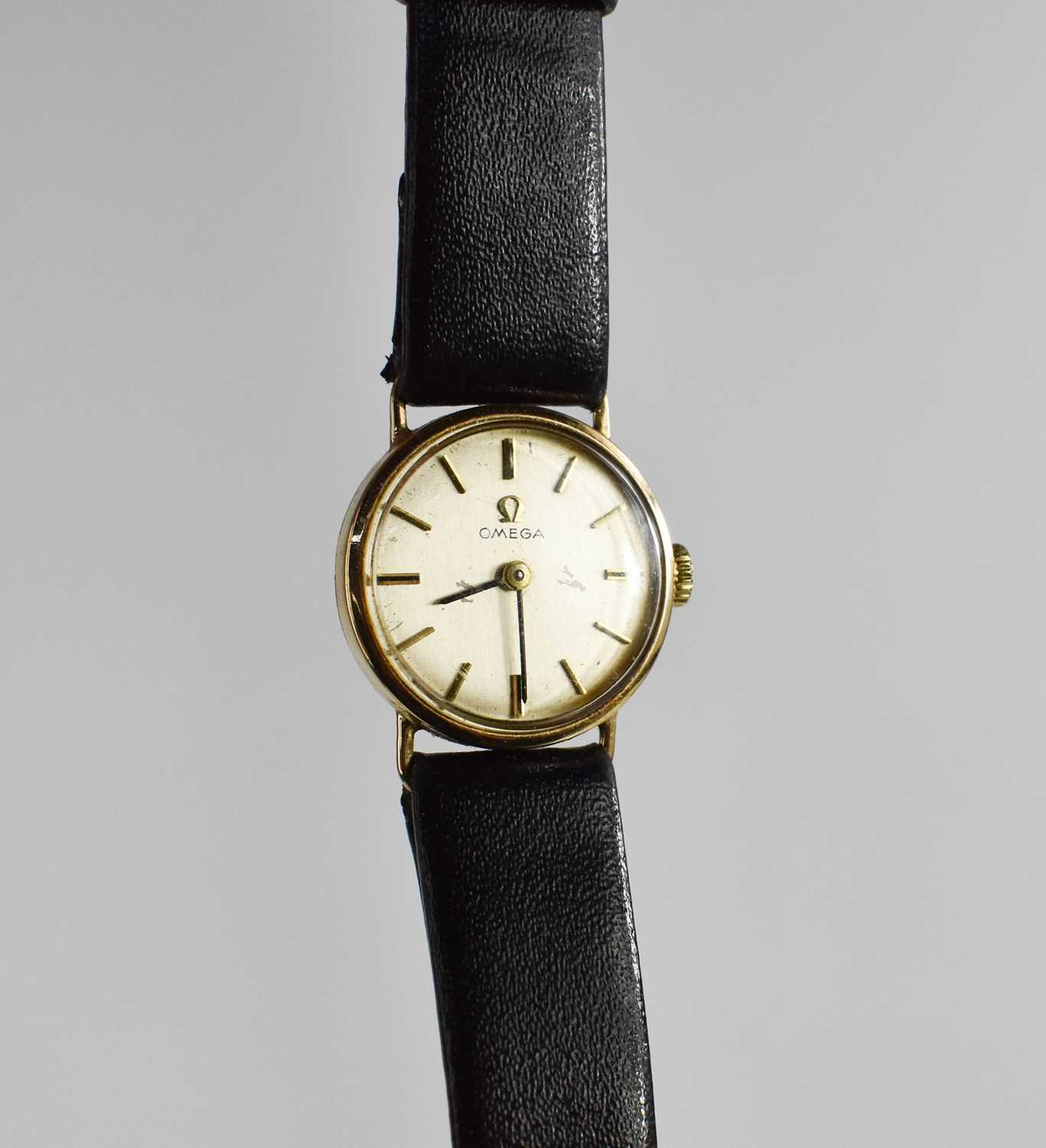 Lot 196 - An Omega 9ct gold wristwatch, with black...