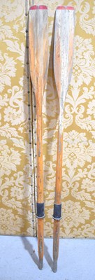 Lot 144 - A pair of vintage wooden rowing oars.