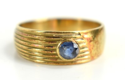 Lot 120 - A 14ct gold band set with a sapphire, size T/U,...