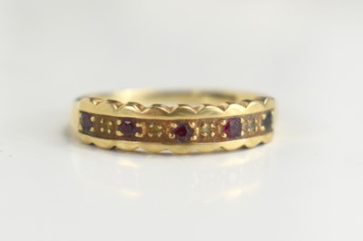 Lot 87 - A 9ct gold ruby and diamond nine stone ring,...