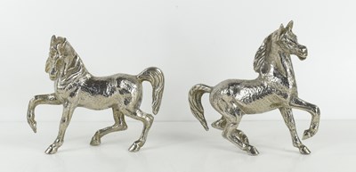 Lot 386 - A pair of silver plated prancing horses.