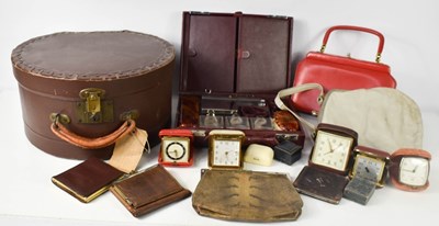 Lot 234 - A group of vintage travel alarm clocks, a red...