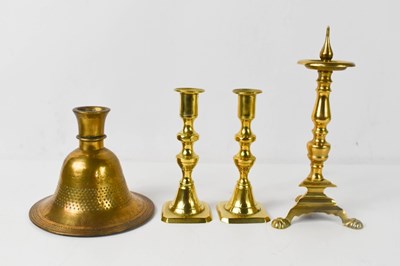 Lot 259 - An early bronze candlestick, of bell form with...