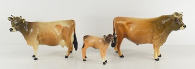 Lot 163 - A Beswick Jersey bull, cow and calf group,...