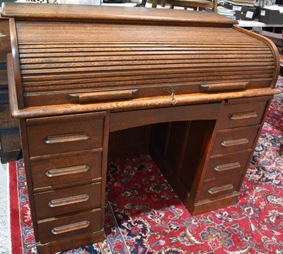 Lot 616 - A 1930s oak roll top desk with tambour slide.