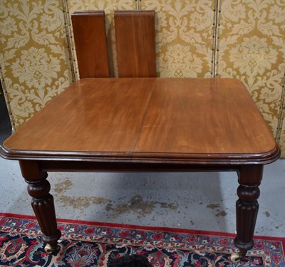 Lot 617 - A Victorian mahogany dining table with two...