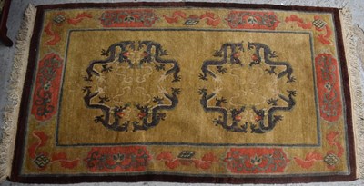 Lot 620 - A Chinese wool rug, depicting dragons on a...