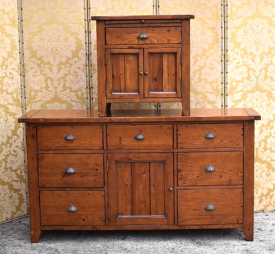 Lot 622 - A pine sideboard with seven drawers and...