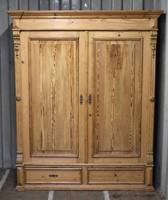 Lot 663 - An antique pine double Wardrobe, with panel...