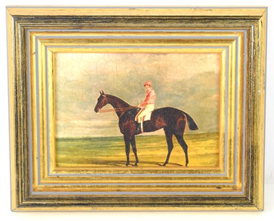 Lot 395 - A small oleograph of a horse and jockey in the...