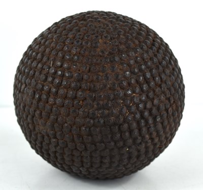 Lot 99 - An antique nail studded boule ball, 11cm high.