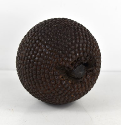 Lot 99 - An antique nail studded boule ball, 11cm high.