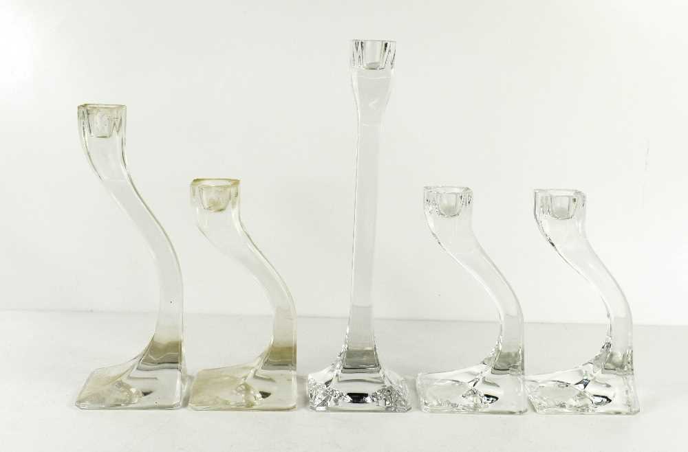 Lot 34 - Five clear glass 'Connect' candlesticks, the...