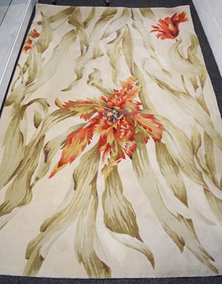 Lot 454 - A pure wool Tropics Collection rug, the cream...