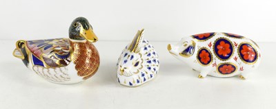 Lot 248 - Three Royal Crown Derby paperweights of a pig,...