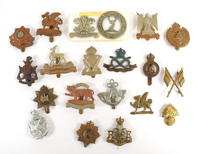 Lot 53 - A collection of military cap badges to include...
