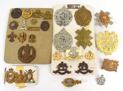 Lot 45 - A group of military cap badges and shoulder...
