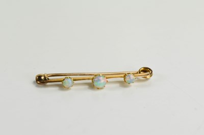 Lot 8 - A Victorian 15ct gold and opal three stone bar...