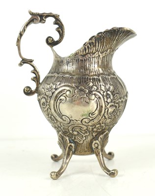 Lot 377 - A continental silver cream jug with repousse...