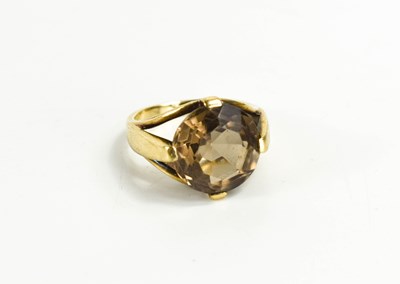 Lot 57 - A 9ct gold and smokey quartz dress ring, the...