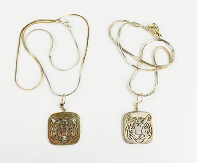 Lot 199 - Two silver pendants, pierced to depict tiger...