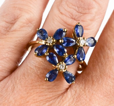 Lot 94 - A 9ct gold, sapphire and diamond multi-flower...