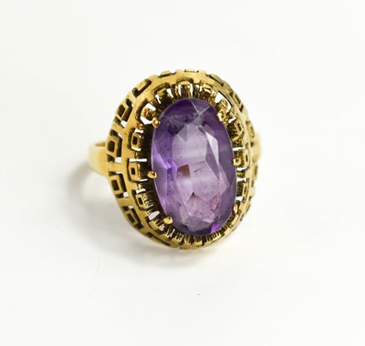 Lot 33 - A large oval set amethyst ring, in raised...