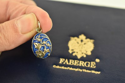 Lot 172 - A Faberge enamel and silver egg form pendant,...