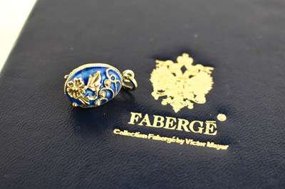 Lot 172 - A Faberge enamel and silver egg form pendant,...