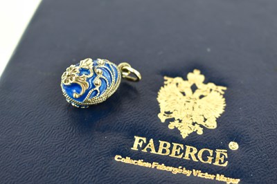 Lot 172 - A Faberge enamel and silver egg form pendant,...