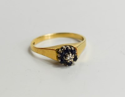 Lot 128 - An 18ct gold sapphire and diamond flowerhead...