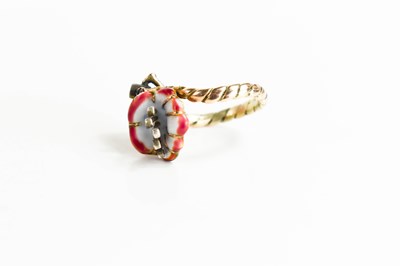 Lot 2 - A gold, enamel and diamond ring in the form of...