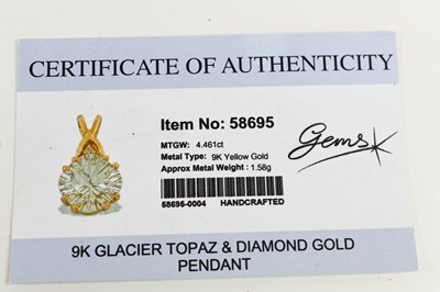 Lot 38 - A glacier topaz and diamond pendant, the topaz...