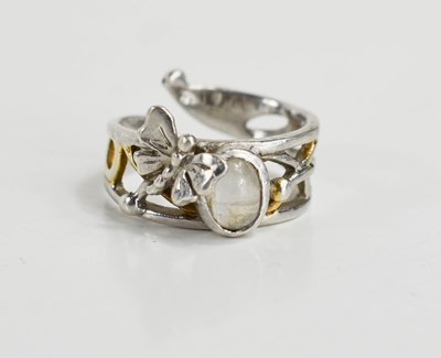 Lot 192 - A moonstone, silver and parcel gilt ring, of...