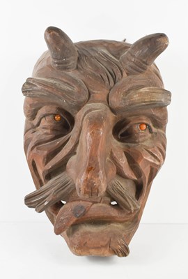 Lot 249 - A 20th century wooden carved horned devil face...